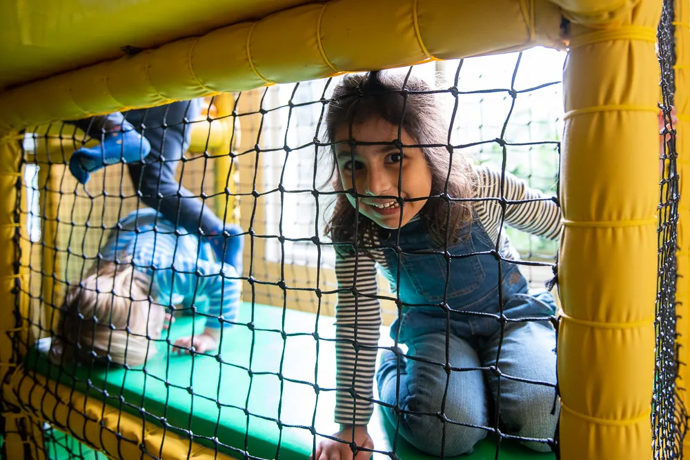 Child plays in soft play